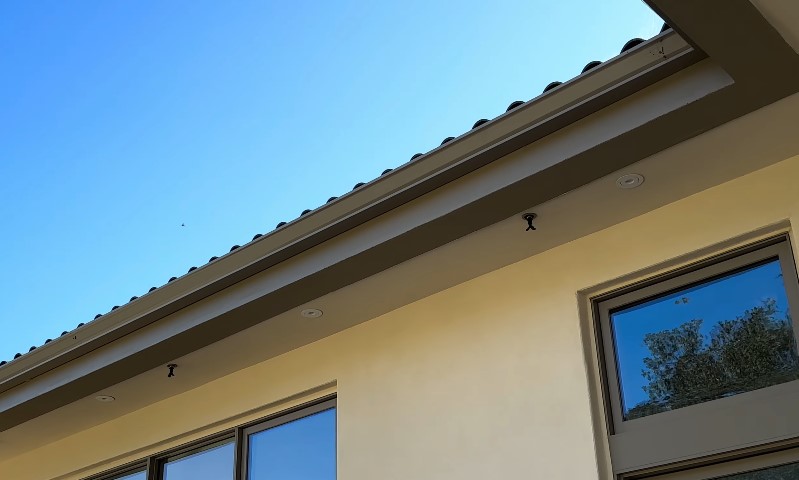 A view of a house roof featuring several windows