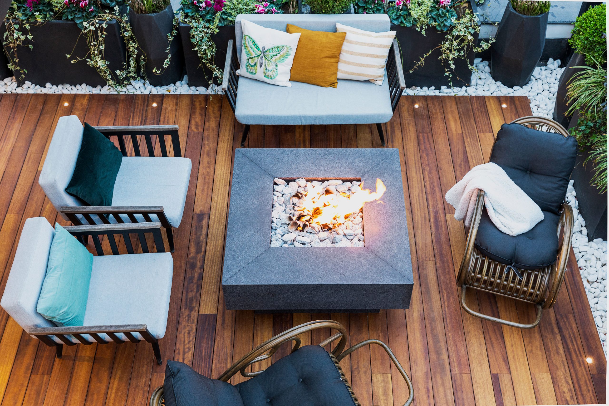 Modern backyard patio with stylish furniture and a central fire pit for outdoor entertaining.